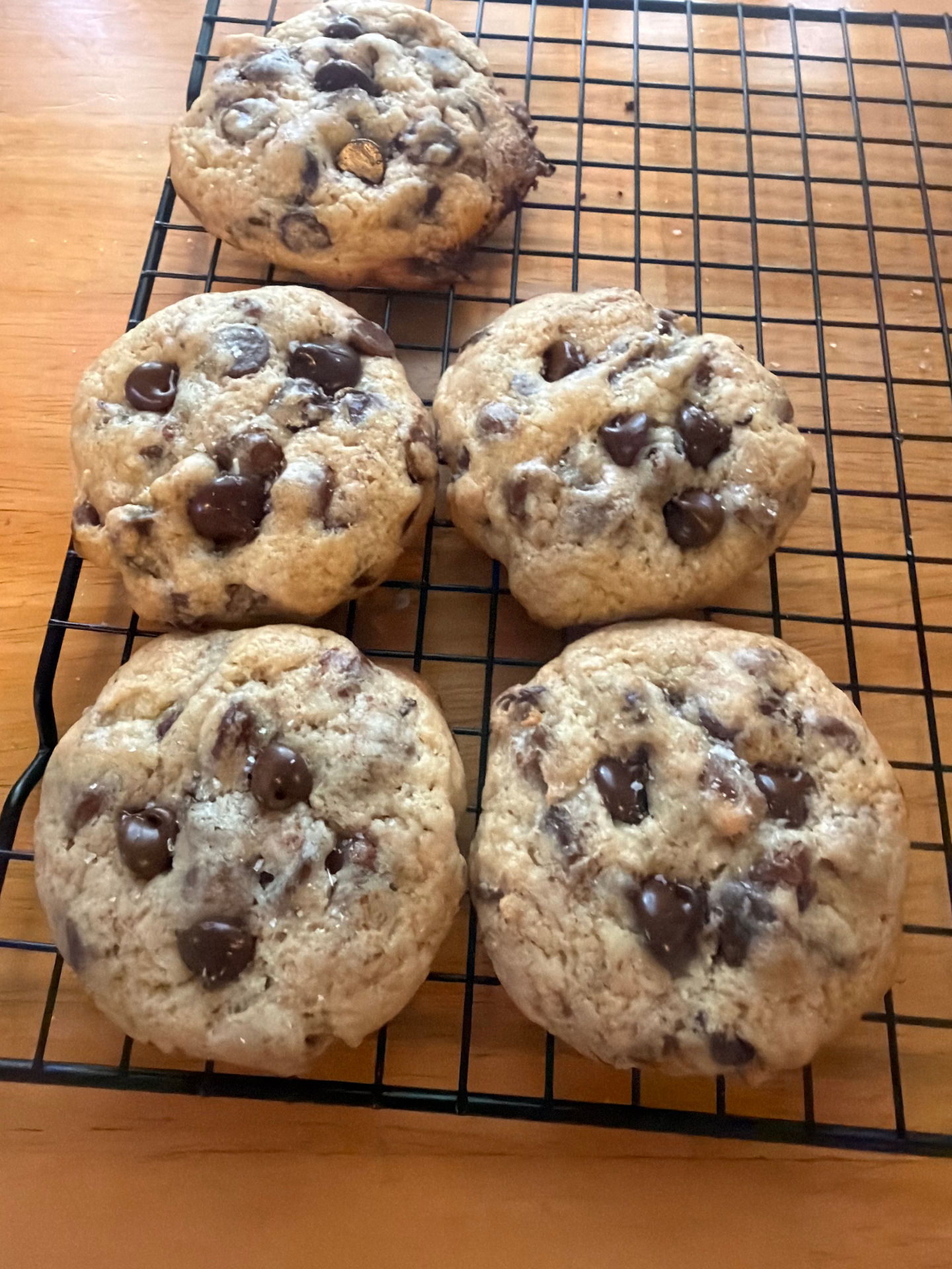 Fresh baked sourdough chocolate chip cookies on a cooling rack